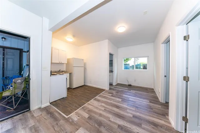 a view of a kitchen with sink and refrigerator