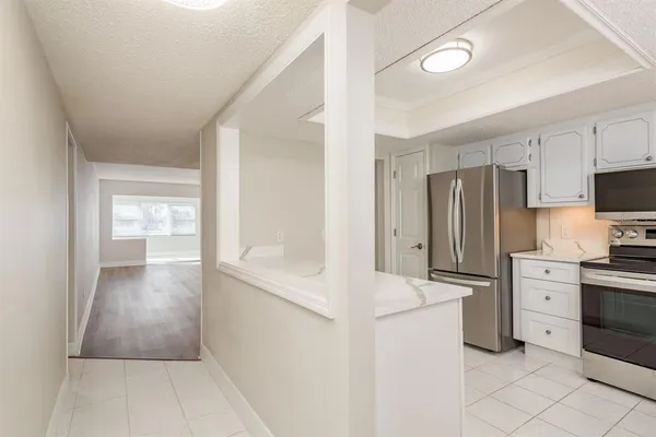 a spacious bathroom with a granite countertop sink and a mirror