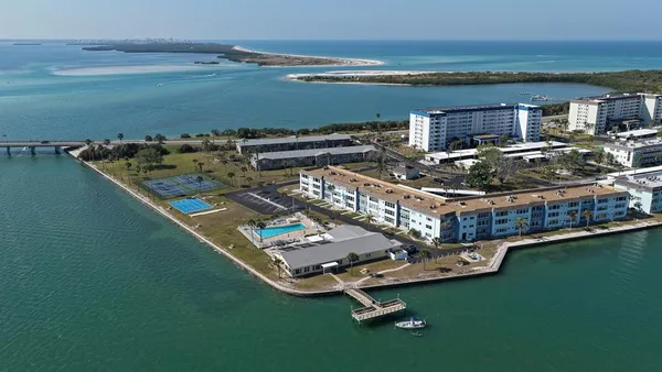 a kitchen with white cabinets stainless steel appliances and sink