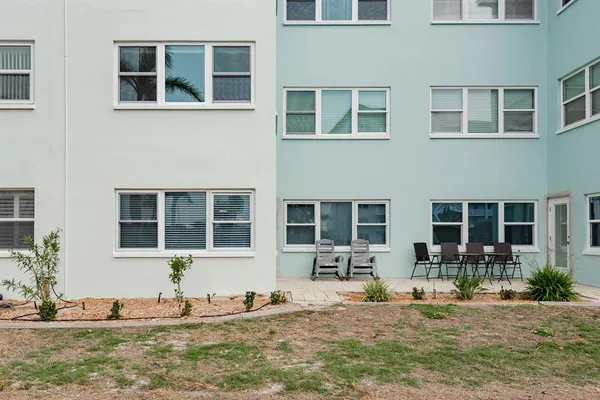 a living room with a table chairs and a window