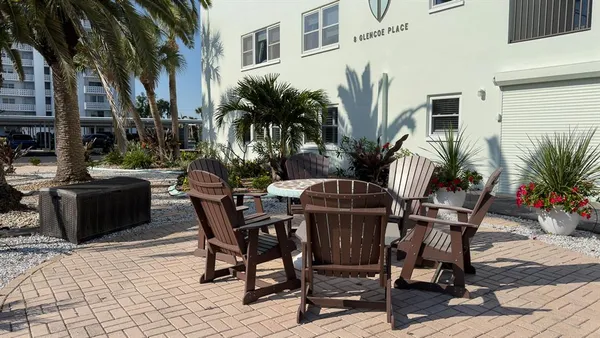 a view of a swimming pool with lawn chairs