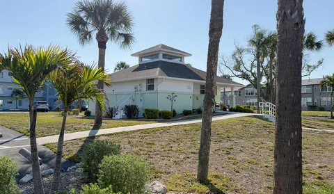 a view of a swimming pool with lawn chairs