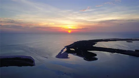 a kitchen with cabinets appliances a sink and a counter top space