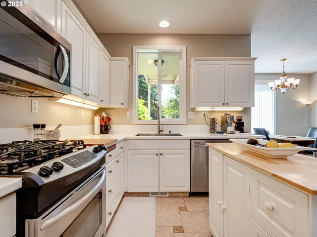a kitchen with a stove a sink and a microwave