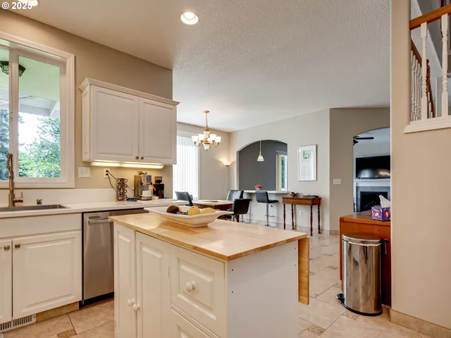 a kitchen with appliances a sink and cabinets