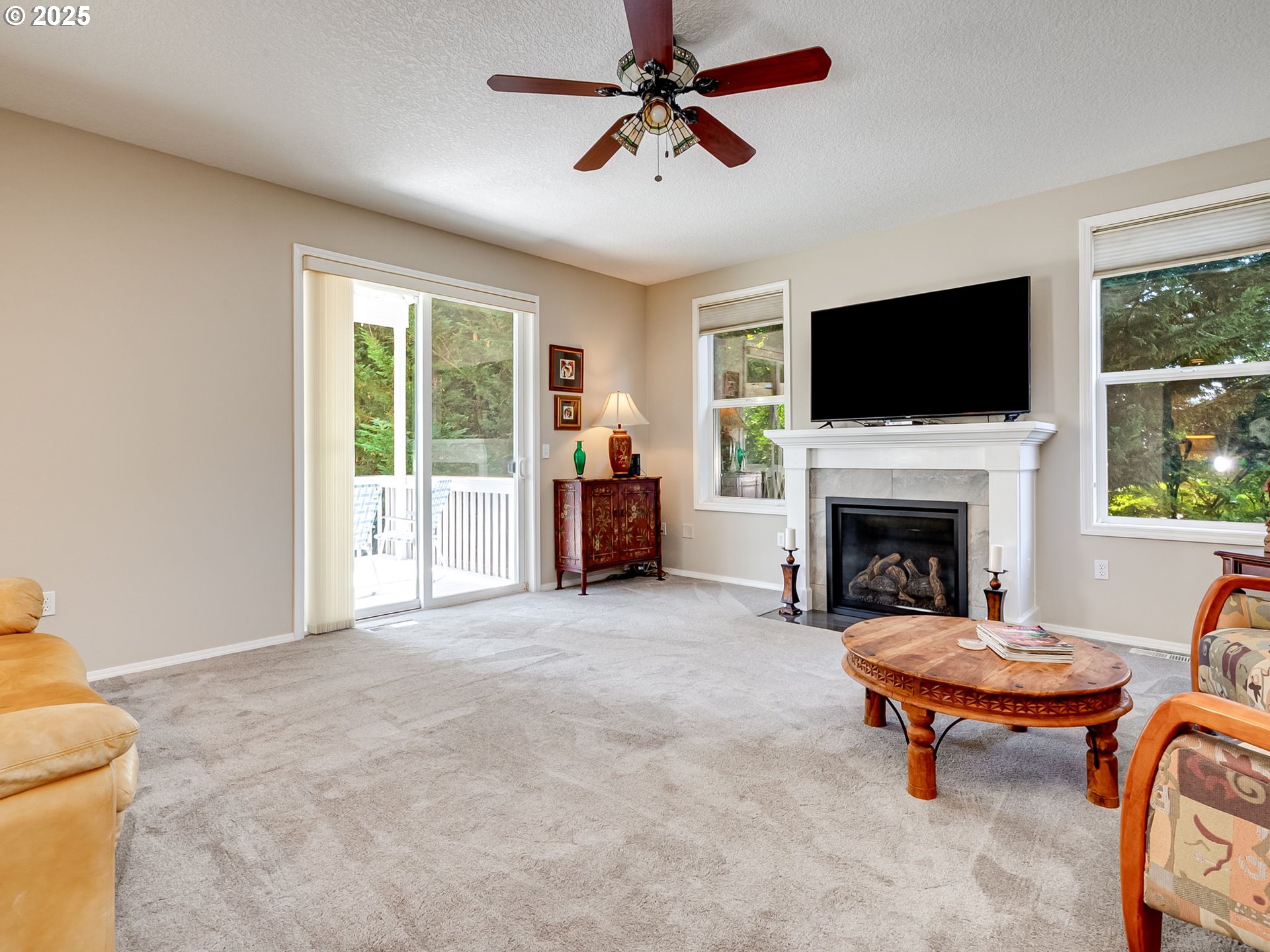 756 Sunset Ridge Drive Washougal, WA 98671 - Photo 18 of 47 a living room with furniture a flat screen tv and a fireplace