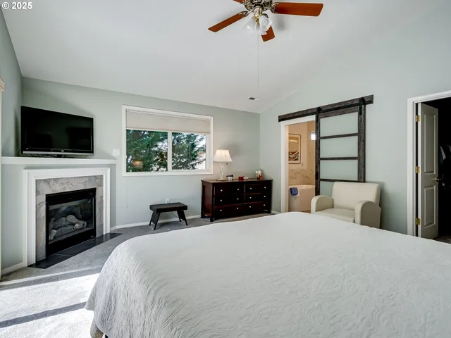 a bedroom with a large bed and a tv