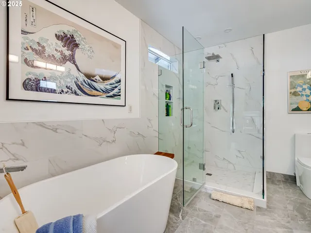 a bathroom with a bathtub and a shower