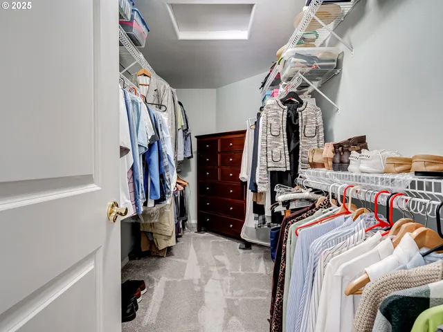 a view of walk in closet with clothes
