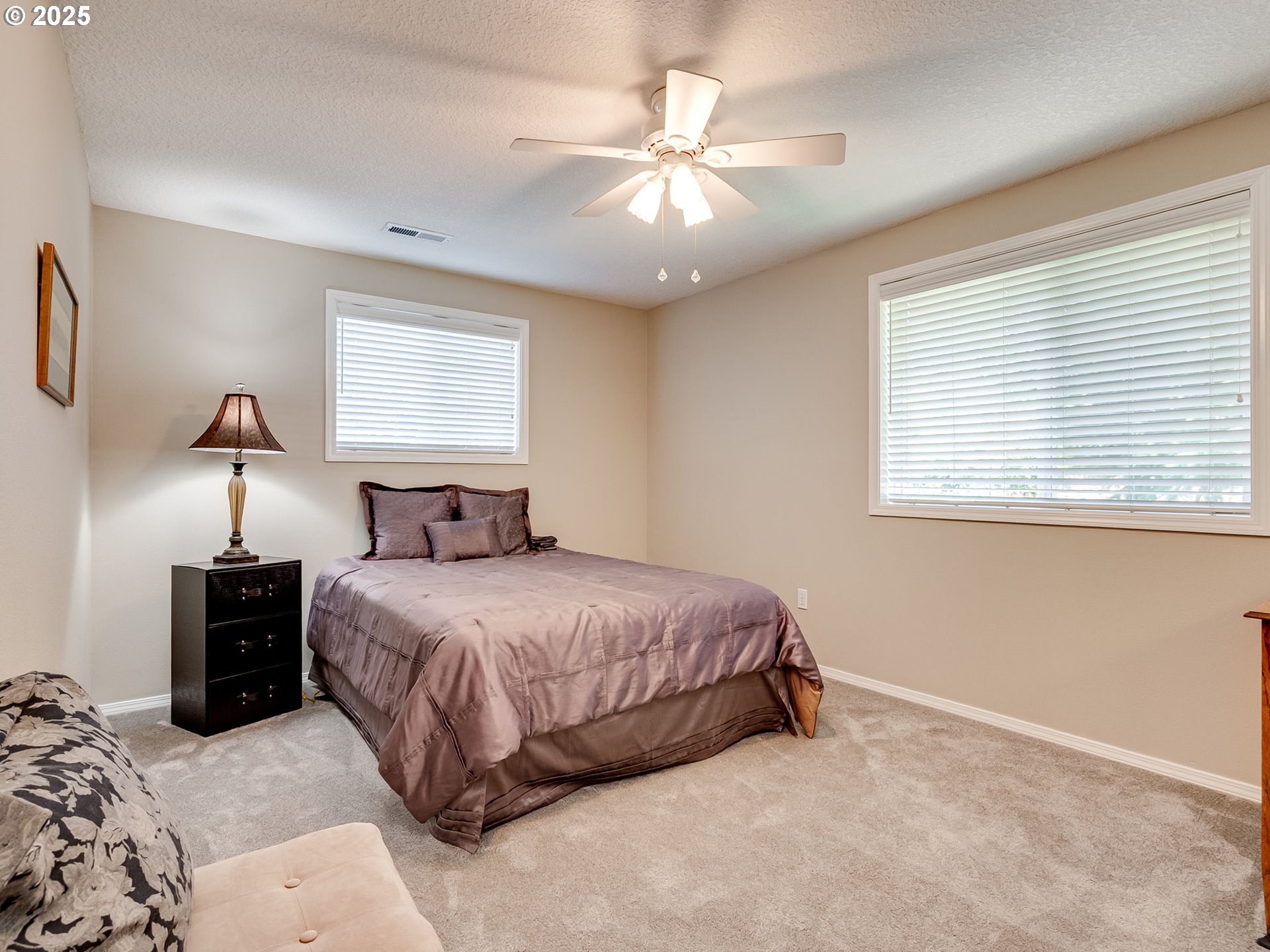 756 Sunset Ridge Drive Washougal, WA 98671 - Photo 34 of 47 a spacious bedroom with a bed and a chandelier