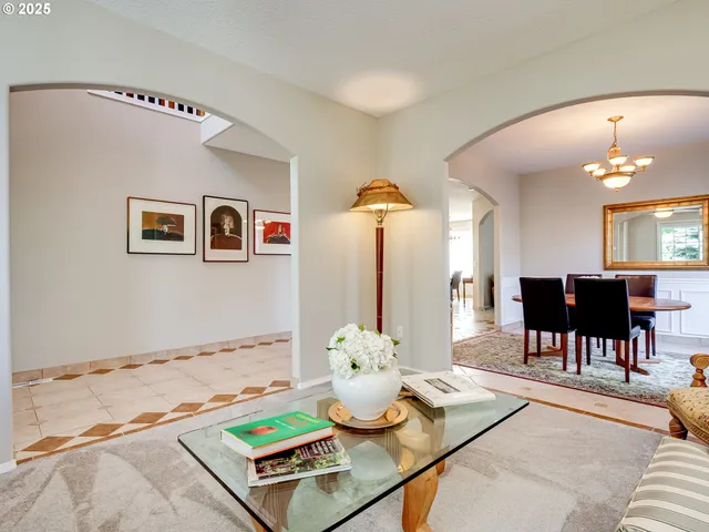 a living room with furniture and view of kitchen