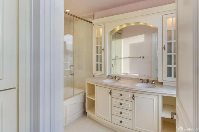 a bathroom with a granite countertop sink mirror and a bathtub