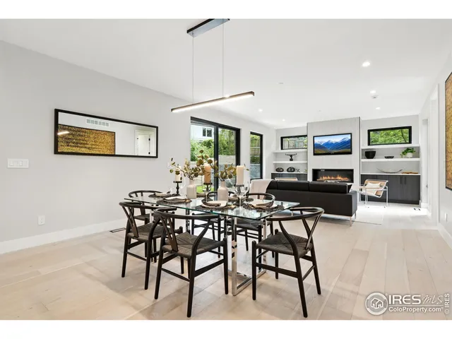 a view of a dining room with furniture and a potted plant