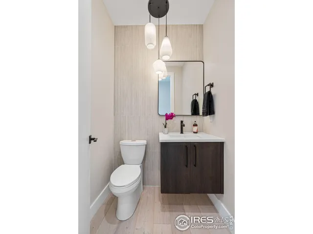 a bathroom with a sink toilet and mirror