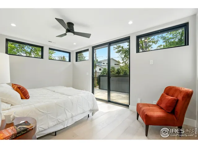 a bedroom with a bed and glass window