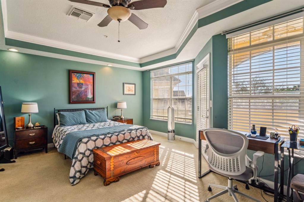 6319 Sunset Bay Circle Apollo Beach, FL 33572 - Photo 60 of 87 a bedroom with a bed chair and a large window