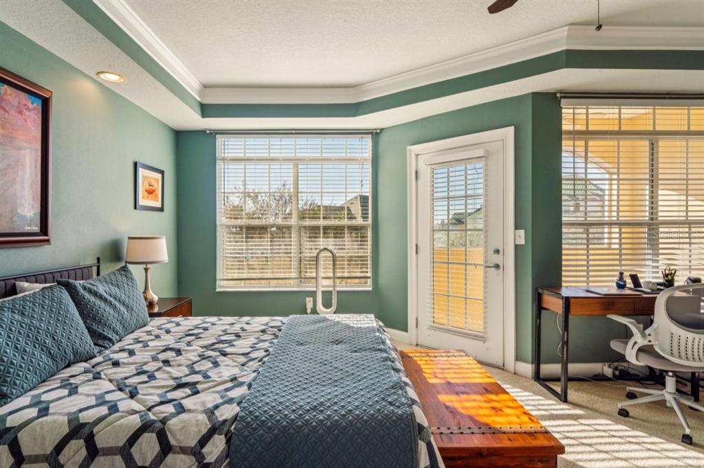 6319 Sunset Bay Circle Apollo Beach, FL 33572 - Photo 61 of 87 a bedroom with a bed and wooden floor