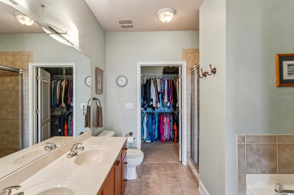 6319 Sunset Bay Circle Apollo Beach, FL 33572 - Photo 66 of 87 a en suite bathroom with a sink and a mirror