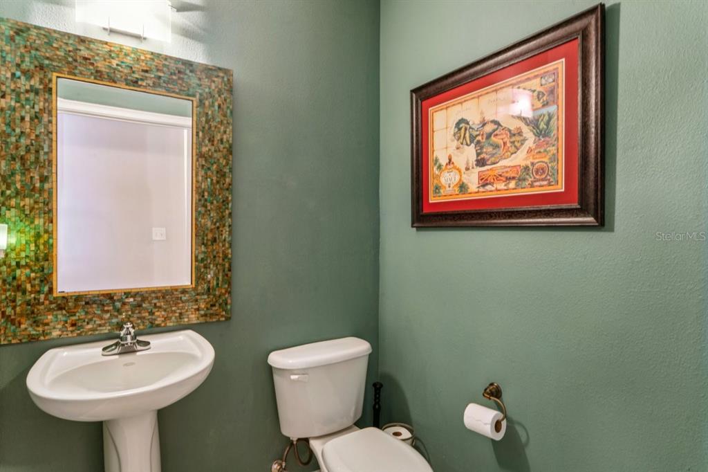 6319 Sunset Bay Circle Apollo Beach, FL 33572 - Photo 71 of 87 a bathroom with a toilet sink and mirror