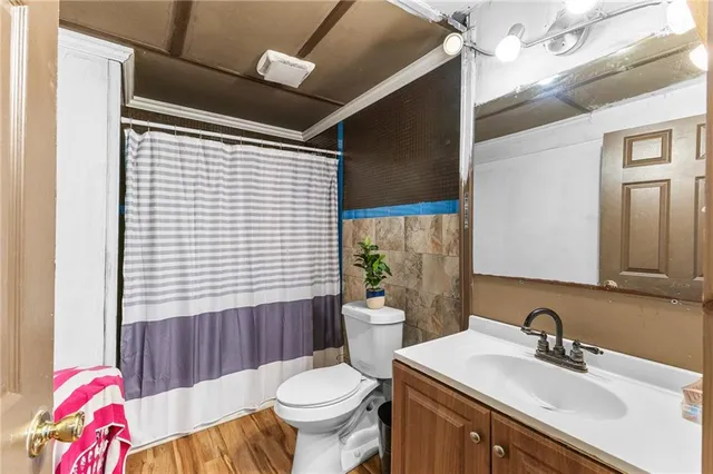 a bathroom with a sink toilet and shower