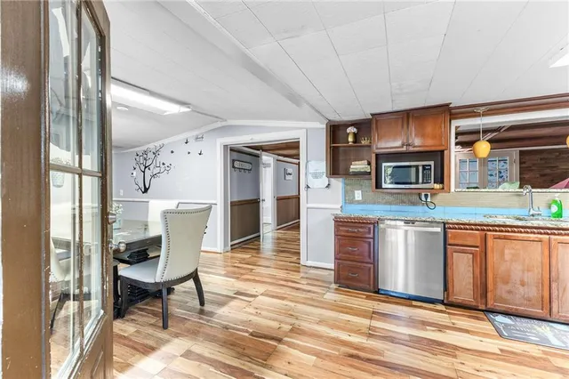a open kitchen with stainless steel appliances granite countertop a stove refrigerator and cabinets
