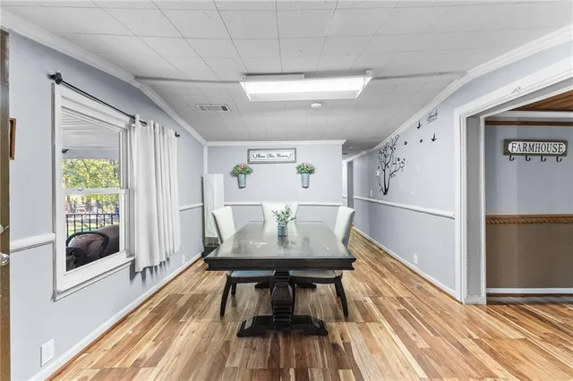 a view of a dining room with furniture window and wooden floor