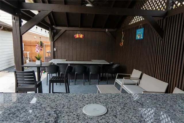 a view of a chairs and table in patio