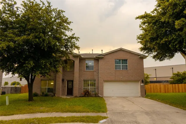 a front view of house with yard and trees