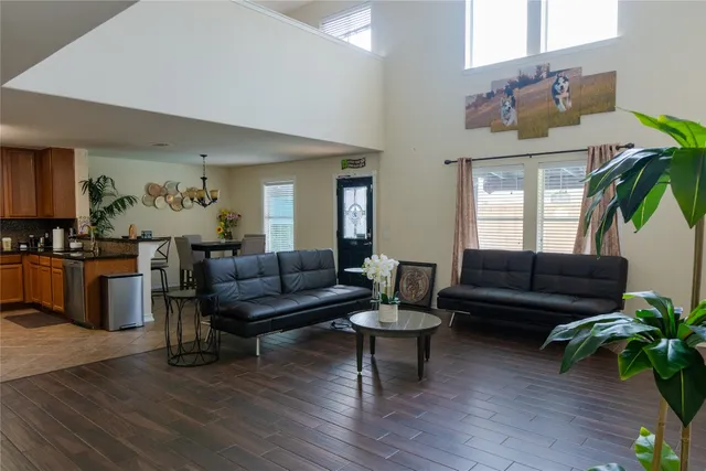 a living room with furniture and wooden floor