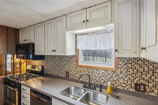a view of a kitchen with a sink and cabinet