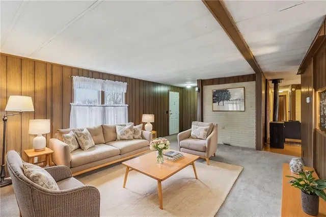a bathroom with a granite countertop sink a mirror a bathtub and shower