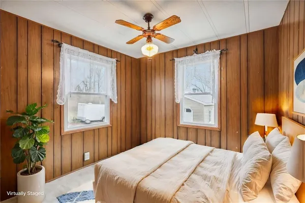 a bedroom with a bed and a window