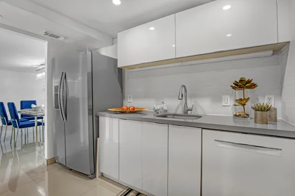 a kitchen with stainless steel appliances a sink and cabinets