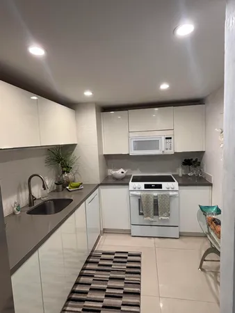 a kitchen with sink and cabinets