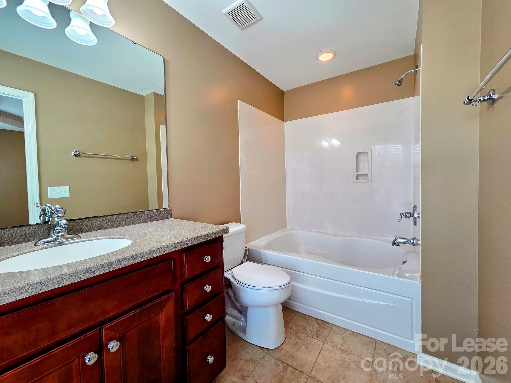 1114 Drayton Court Fort Mill, SC 29708 - Photo 15 of 31 a bathroom with a granite countertop sink a toilet a mirror and bathtub