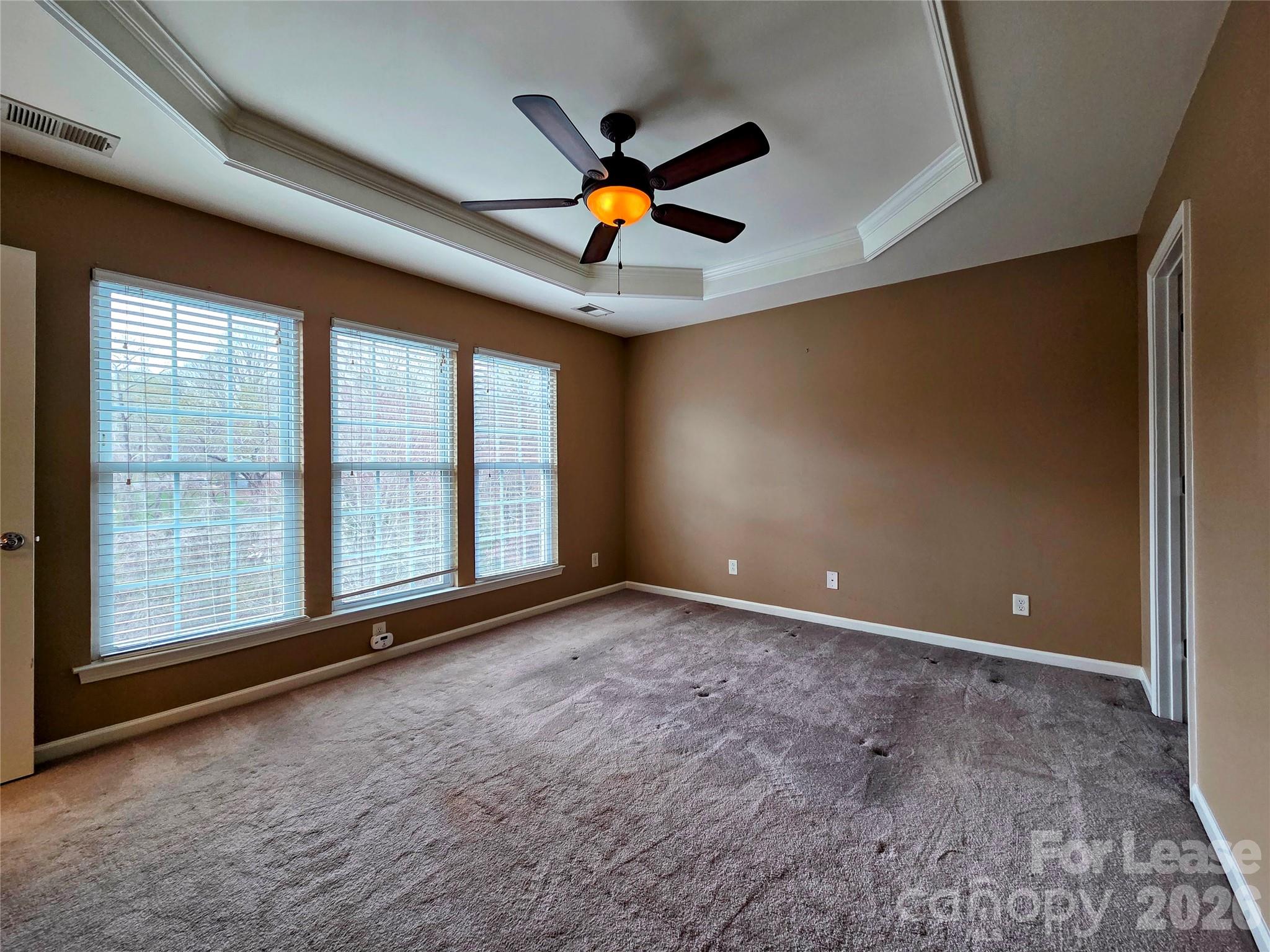 1114 Drayton Court Fort Mill, SC 29708 - Photo 17 of 31 a view of an empty room with window and chandelier fan