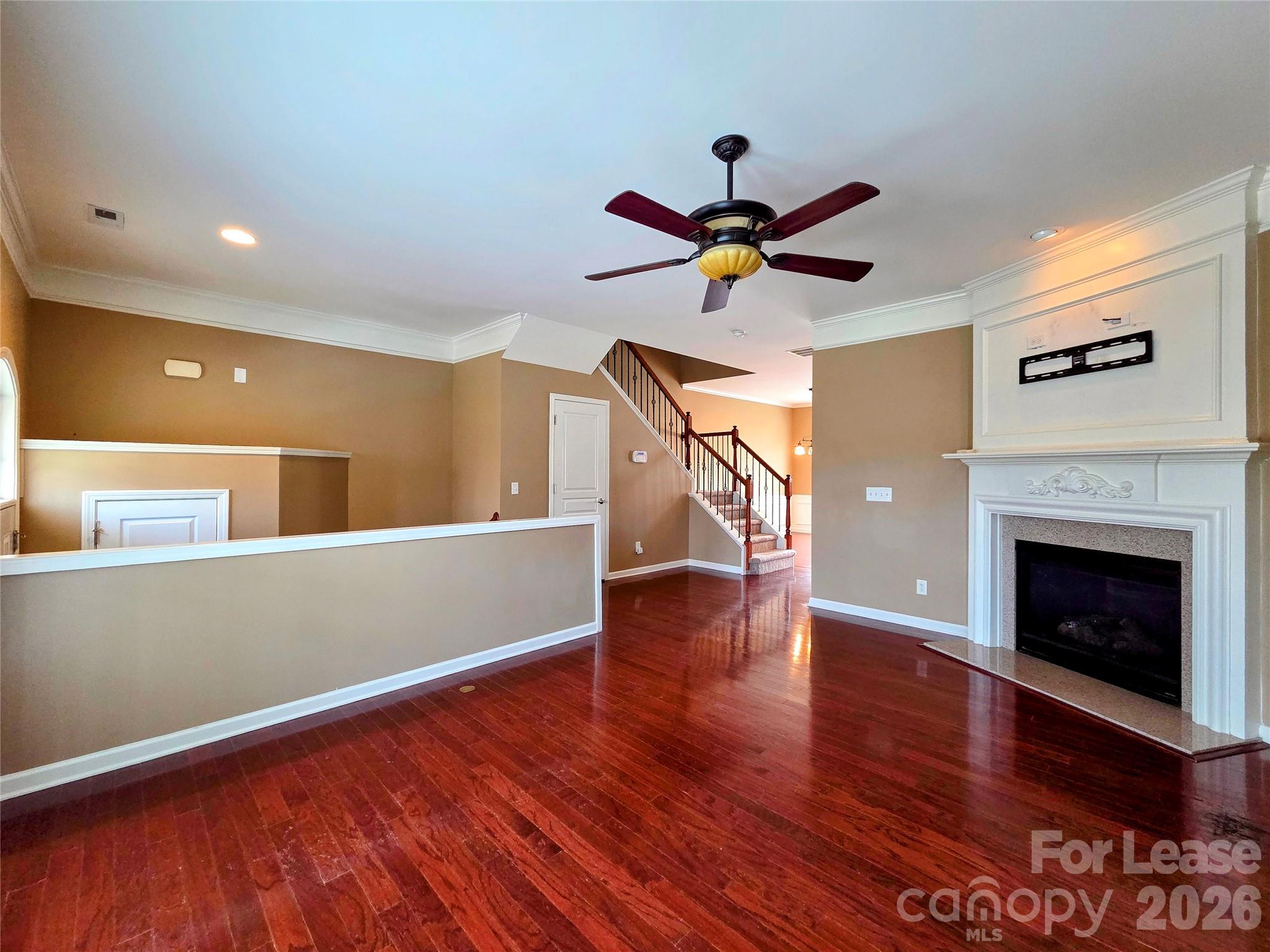 1114 Drayton Court Fort Mill, SC 29708 - Photo 6 of 31 a view of a room with wooden floor and a ceiling fan
