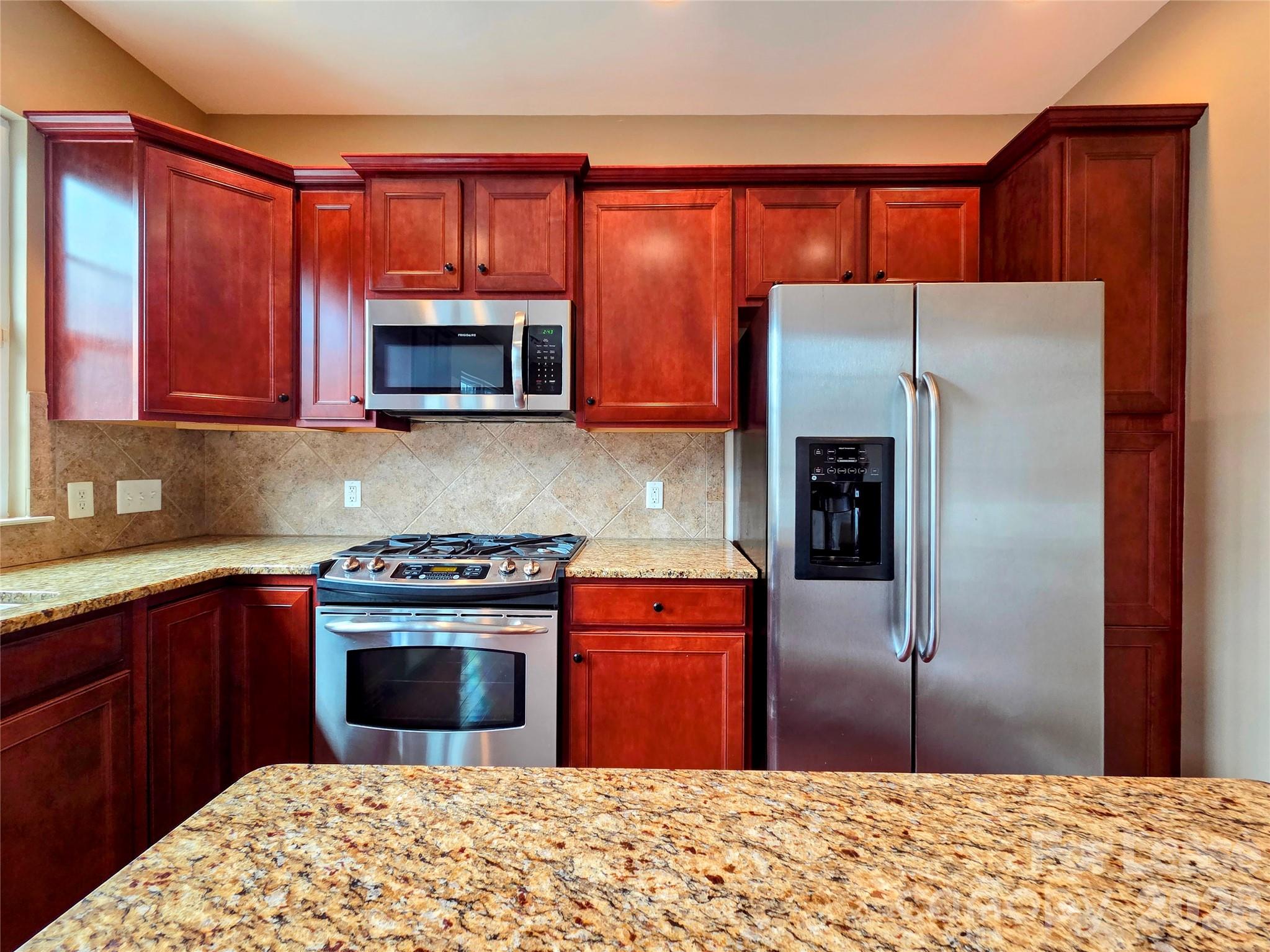 1114 Drayton Court Fort Mill, SC 29708 - Photo 10 of 31 a kitchen with stainless steel appliances granite countertop a refrigerator stove and sink