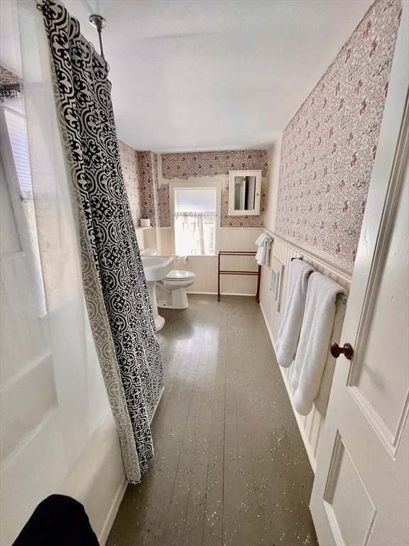 4 Traders Lane Nantucket, MA 02554 - Photo 13 of 15 a living room with furniture and a floor to ceiling window