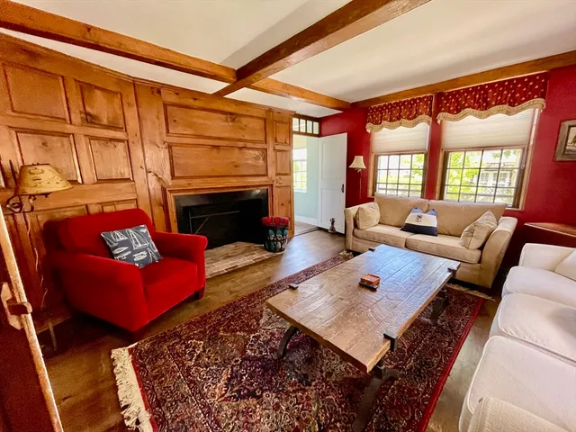 a living room with furniture rug and a fireplace