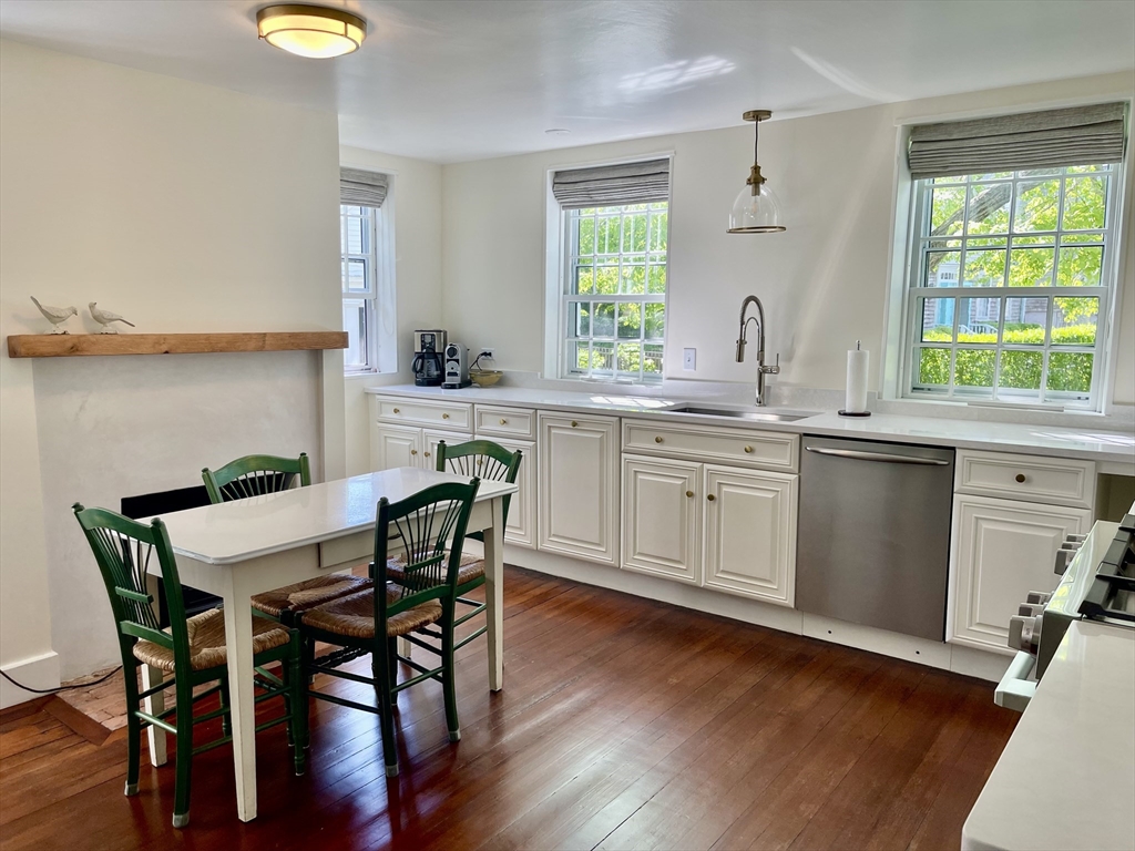 4 Traders Lane Nantucket, MA 02554 - Photo 7 of 15 a kitchen with a table chairs sink and cabinets