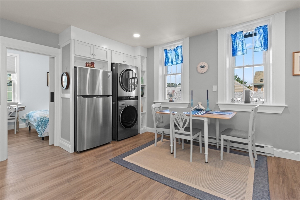 40 Middle Street, Unit 2 Gloucester, MA 01930 - Photo 12 of 21 a dining room with furniture a rug a fireplace and wooden floor