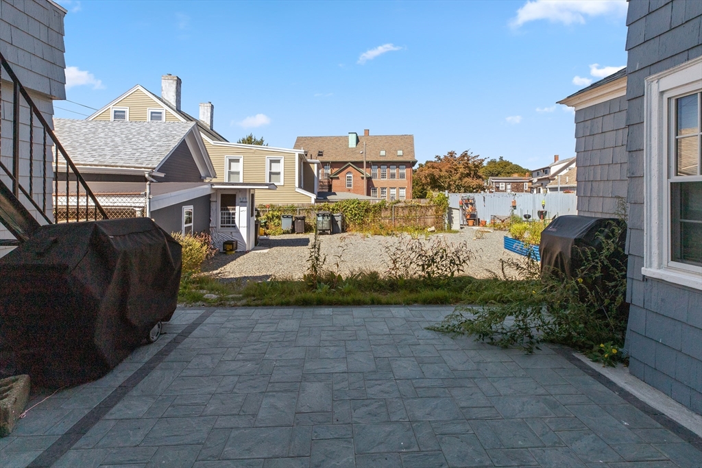 40 Middle Street, Unit 2 Gloucester, MA 01930 - Photo 14 of 21 a view of a house with a yard and potted plants