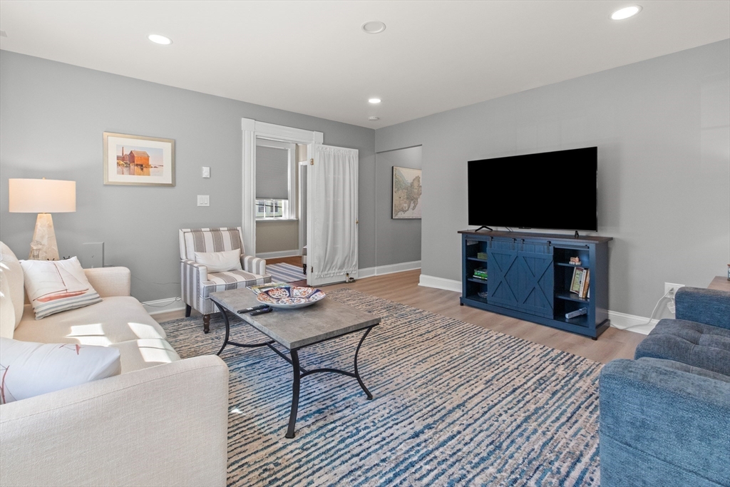 40 Middle Street, Unit 2 Gloucester, MA 01930 - Photo 6 of 21 a living room with furniture and a flat screen tv