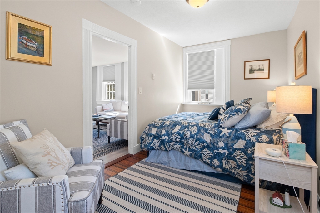 40 Middle Street, Unit 2 Gloucester, MA 01930 - Photo 7 of 21 a bedroom with a bed and wooden floor