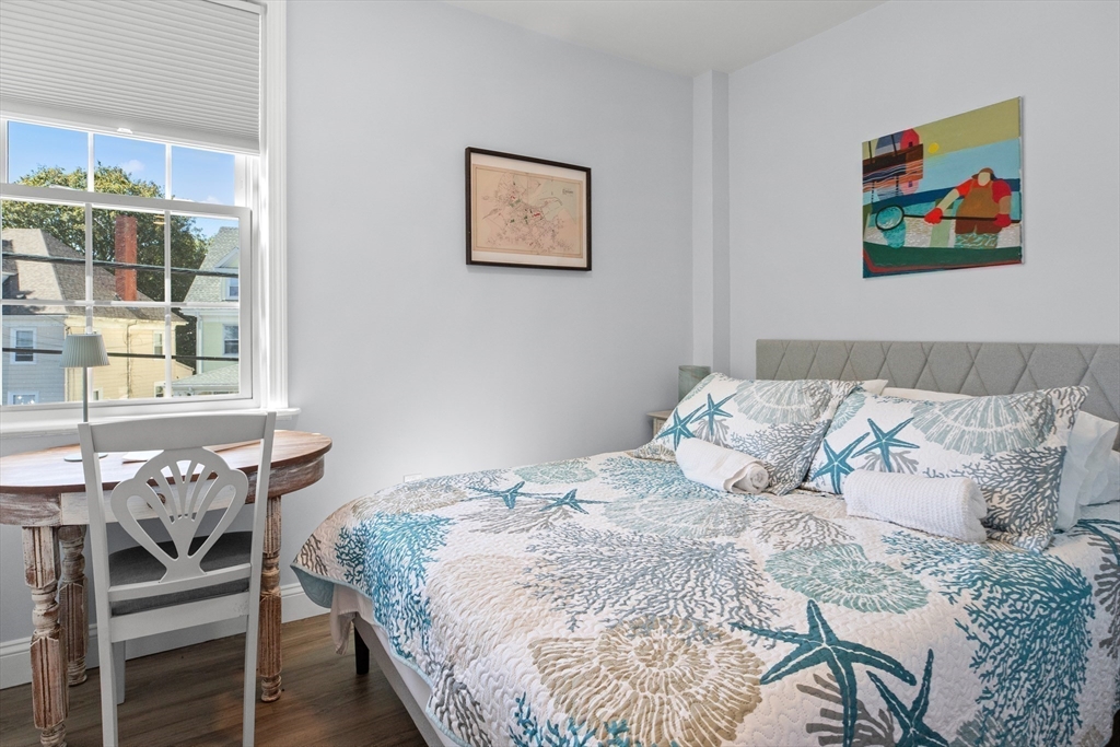 40 Middle Street, Unit 2 Gloucester, MA 01930 - Photo 8 of 21 a bedroom with a bed and a painting on the wall