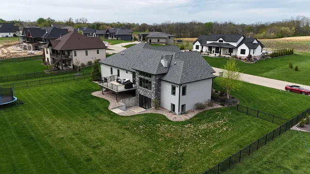 an aerial view of a house with garden space and street view