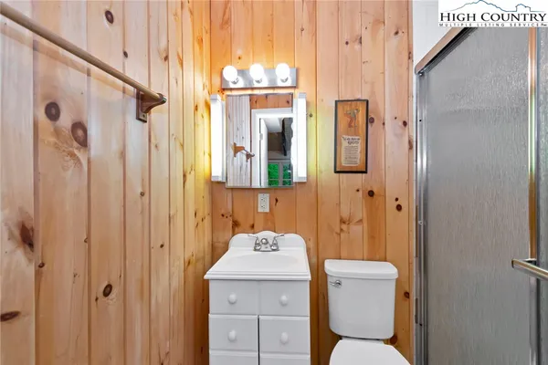 a bathroom with a toilet a sink and shower