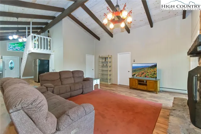 a bedroom with furniture and a chandelier