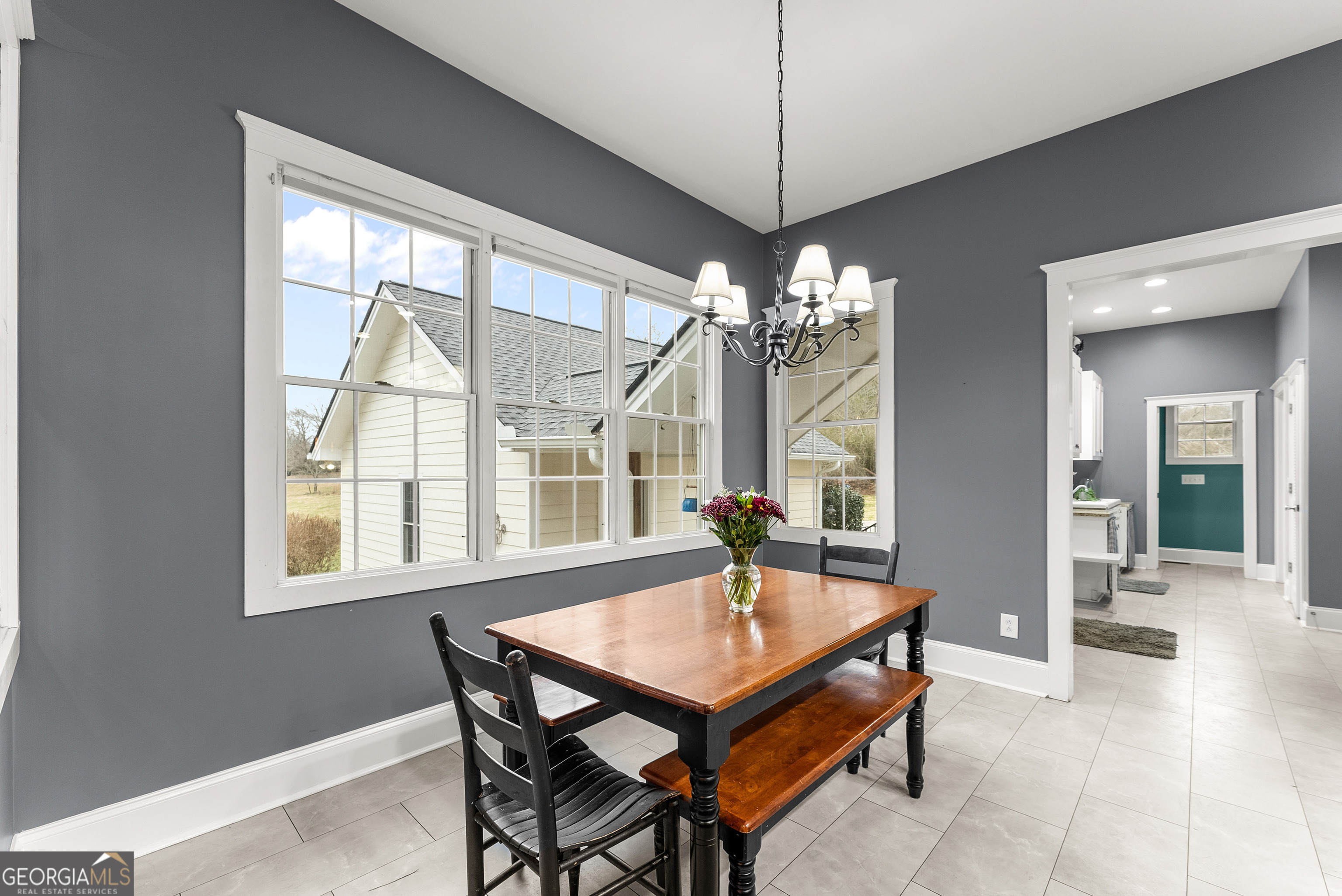 1295 Wall Bridge Loop Clarkesville, GA 30523 - Photo 17 of 76 a dining room with wooden floor a chandelier a wooden table and chairs